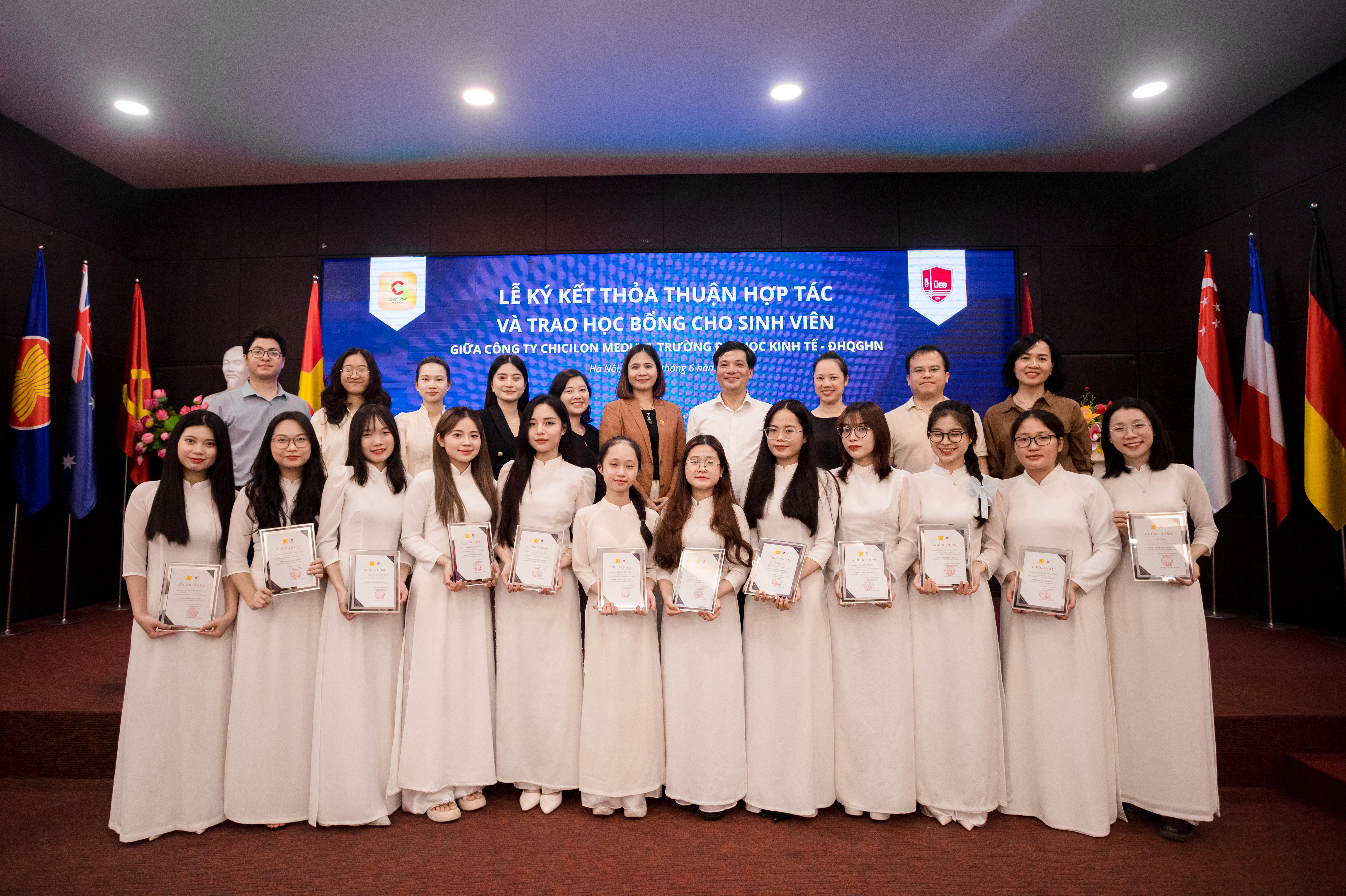 UEB Students receiving scholarships at the award ceremony on June 26